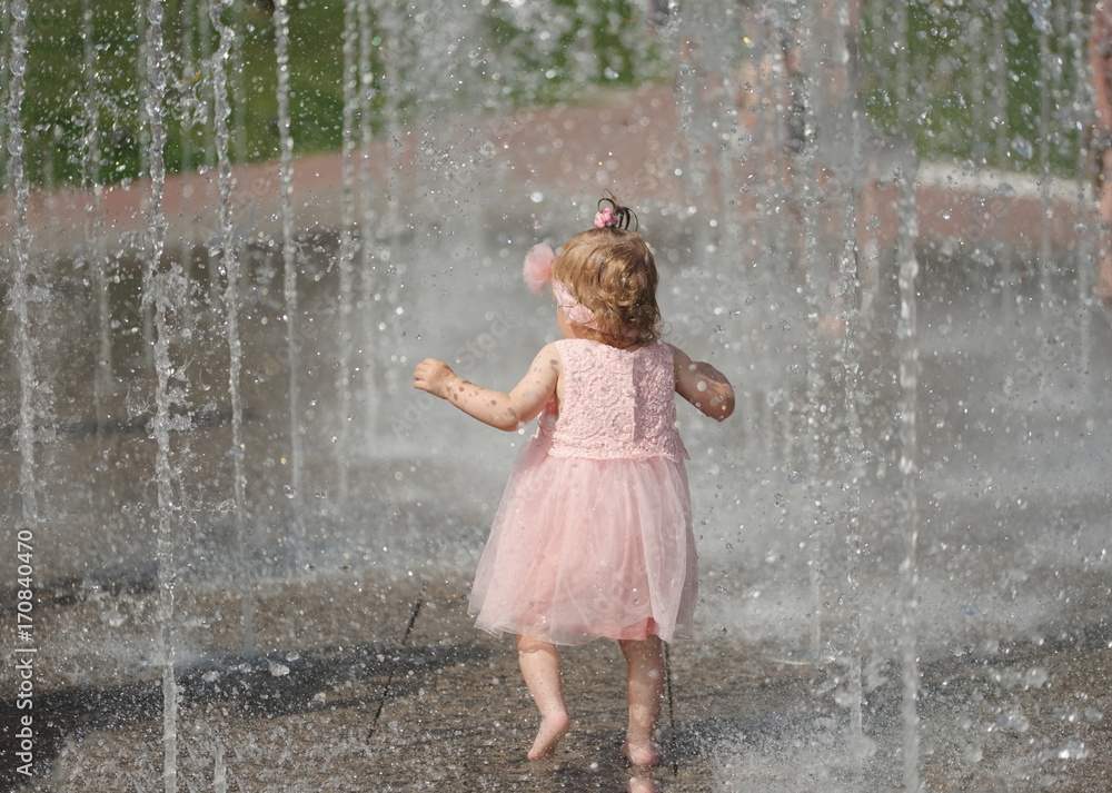 little girl plays with water in fountain little girl plays with water in fountain