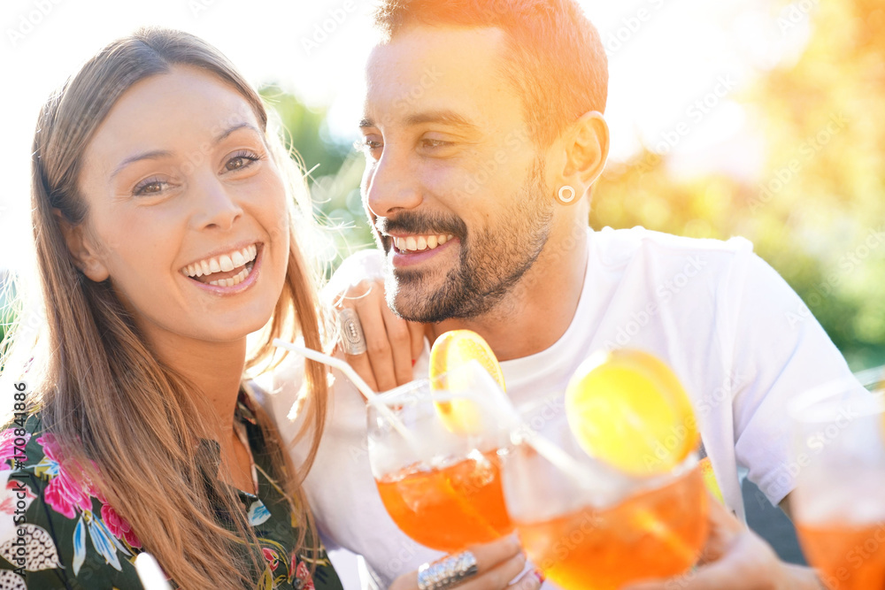 Cheerful couple having fun cheering with cocktails Cheerful couple having fun cheering with cocktails