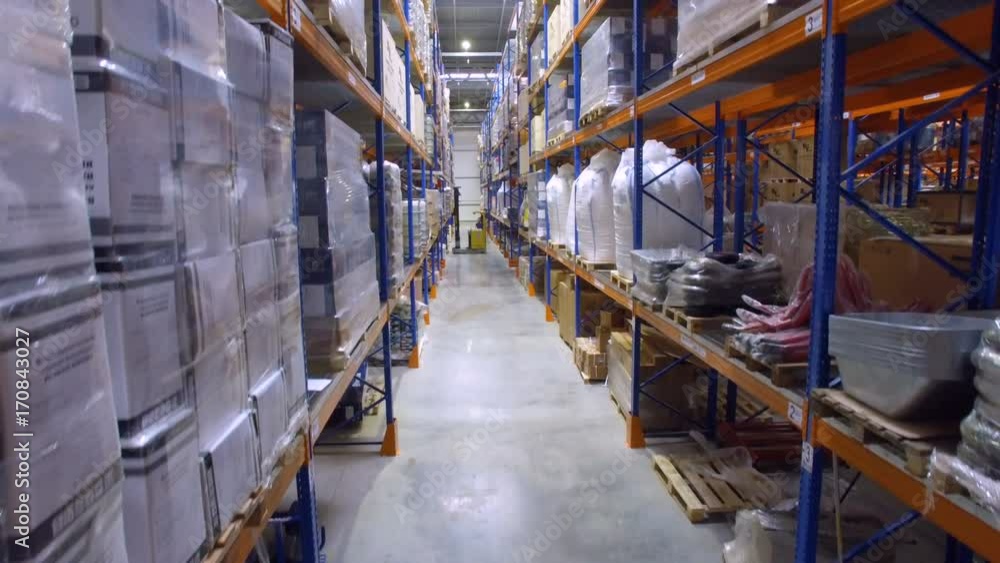 Working forklift loader inside huge industrial Warehouse. Aerial shot. Working forklift loader inside huge industrial Warehouse. Aerial shot.