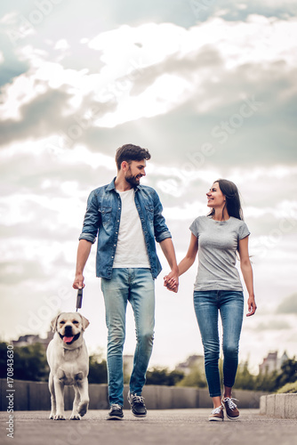 Canvas Print Couple on a walk with dog