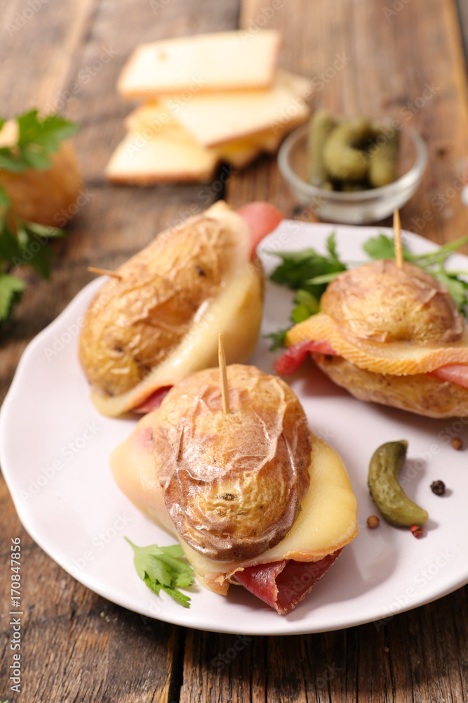 baked potato with cheese raclette and salami baked potato with cheese raclette and salami