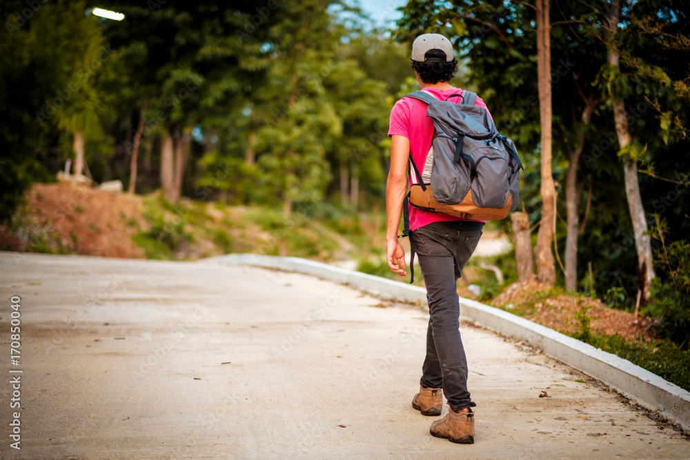 man traveling walking with backpack at national park in the jungle day time sun shine on holiday at weekend relax fresh on background nature view man traveling walking with backpack at national park in the jungle day time sun shine on holiday at weekend relax fresh on background nature view