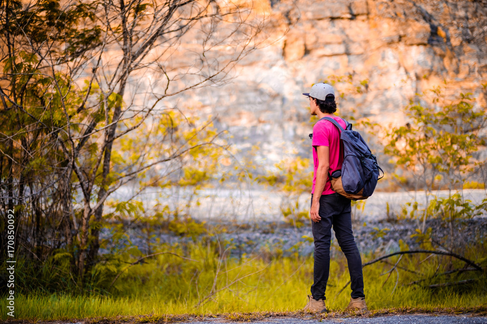 man traveling walking with backpack at national park in the jungle day time sun shine on holiday at weekend relax fresh on background nature view man traveling walking with backpack at national park in the jungle day time sun shine on holiday at weekend relax fresh on background nature view