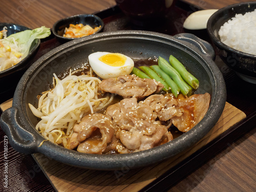 pork teppanyaki with egg and vegetables in hot plate Japanese Cooking