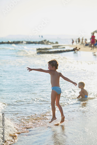 boys playing at sea in the water