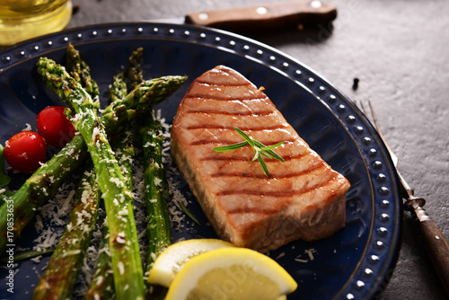 Grilled Tuna steak with roasted asparagus and parmesan photo