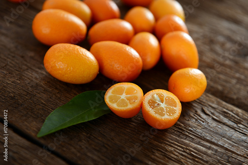 Kumquat fruits on old wooden table photo