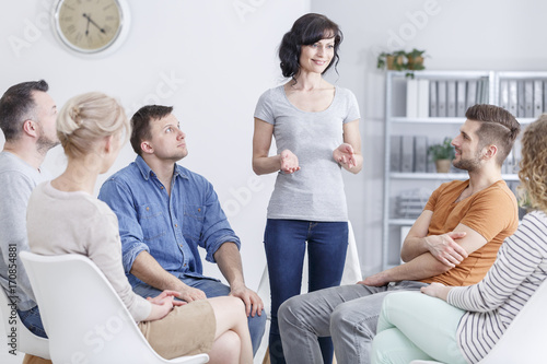 Smiling woman during group conversation photo