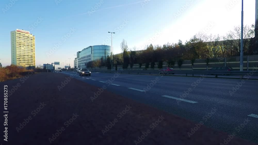 Cars drive on a highway near an urban area - timelapse Cars drive on a highway near an urban area - timelapse
