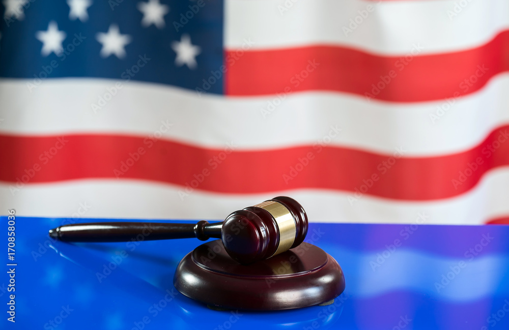 Law and justice symbols on American flag background.