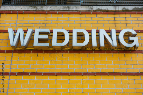 wedding letters on yellow brick facade