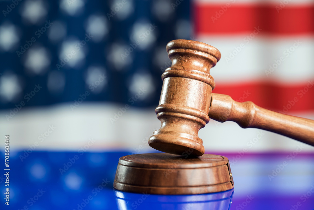 Law and justice symbols on American flag background.