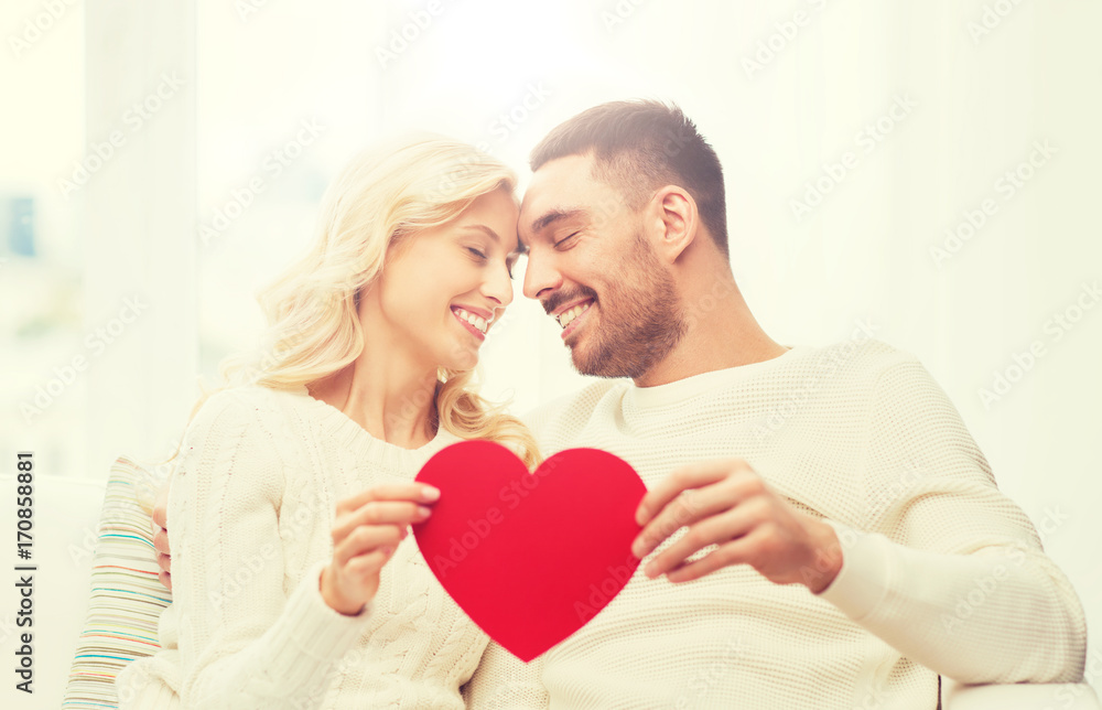 happy couple with red heart hugging at home happy couple with red heart hugging at home