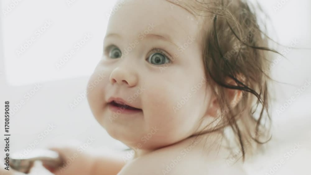 Portrait of baby girl in the kitchen sink. Slowmotion. Handheld Portrait of baby girl in the kitchen sink. Slowmotion. Handheld