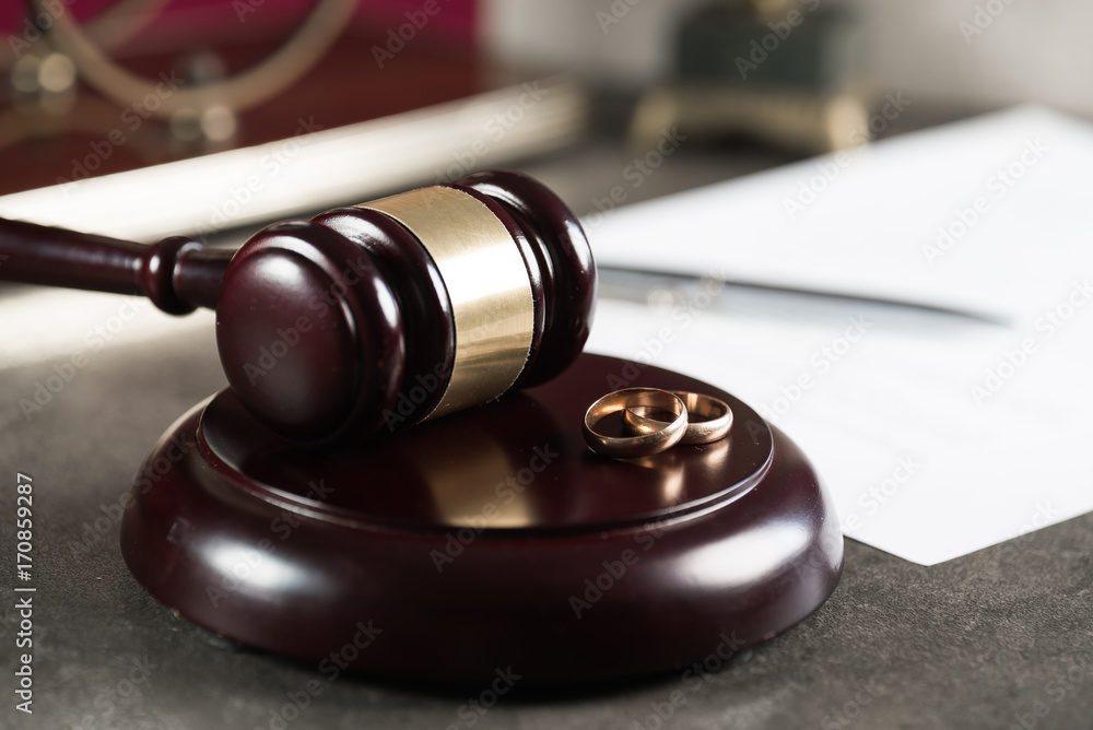 Divorce concept with gavel and wedding rings Divorce concept with gavel and wedding rings