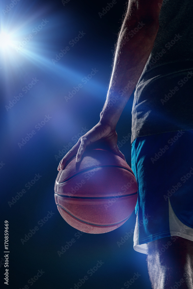 Fototapeta premium The portrait of a basketball player with ball