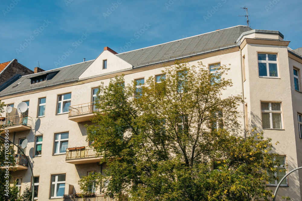 yellow building with green tree