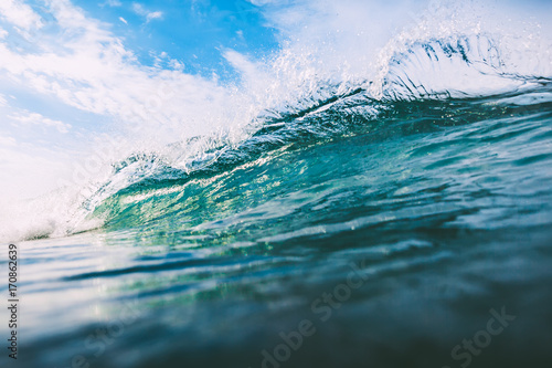 Crashing wave in ocean. Crystal wave and sun