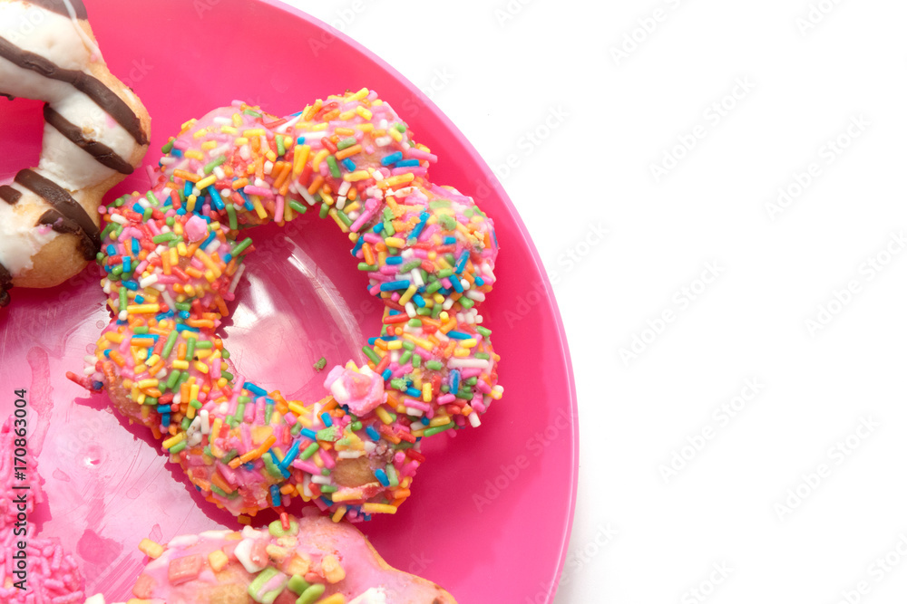 colorful doughnut on pink plate colorful doughnut on pink plate