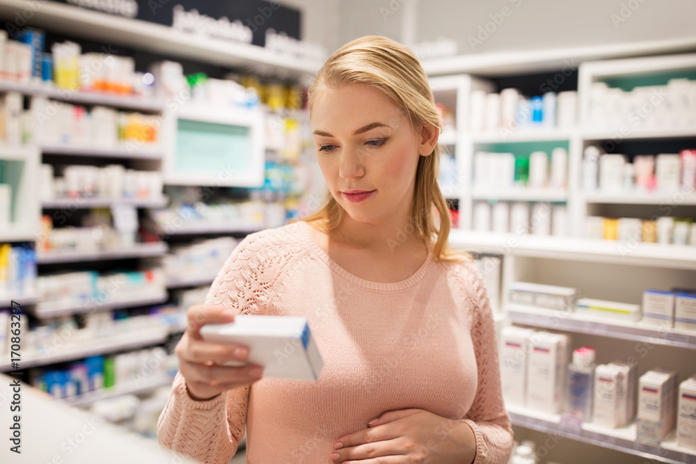 happy pregnant woman with medication at pharmacy happy pregnant woman with medication at pharmacy