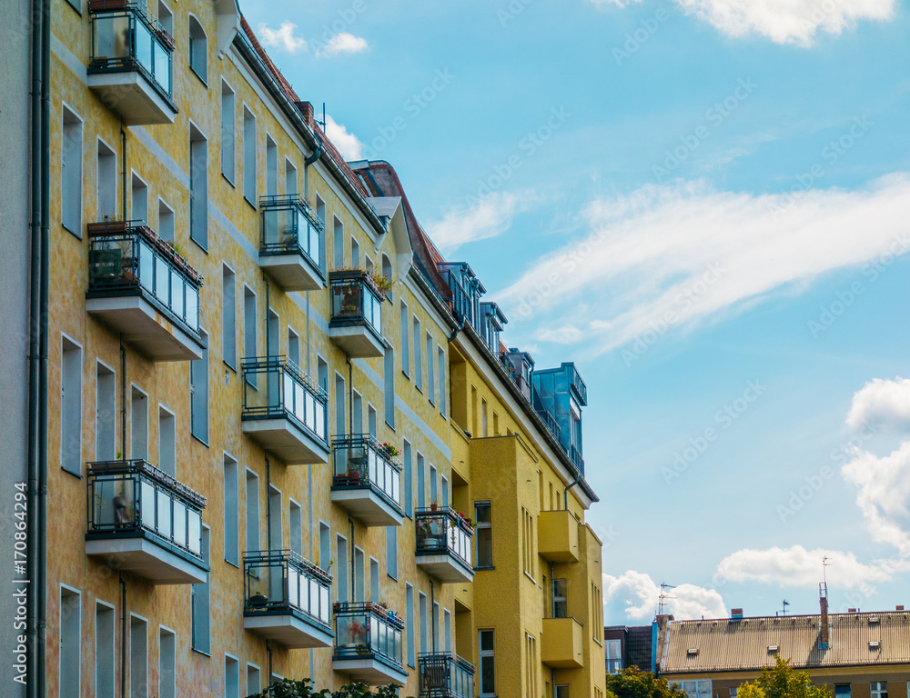 yellow apartment buildings with small balcony