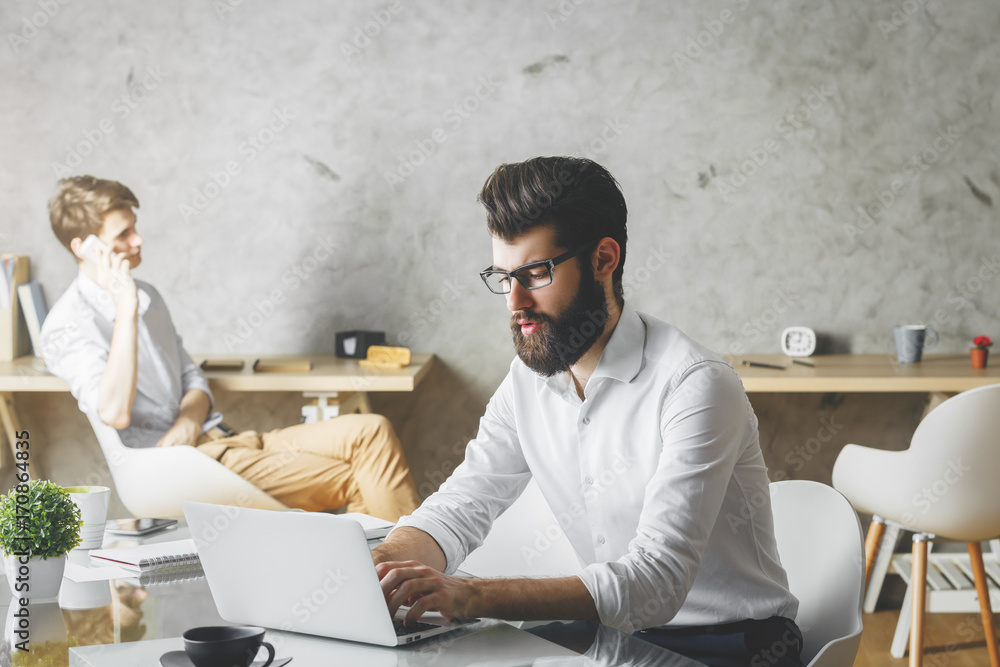 Attractive businessman using laptop Attractive businessman using laptop