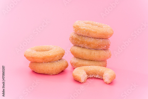 Fried Donuts with sugar topping on pink background
