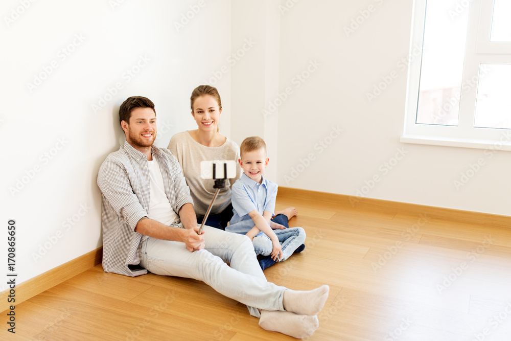 family taking selfie by smartphone at new home family taking selfie by smartphone at new home