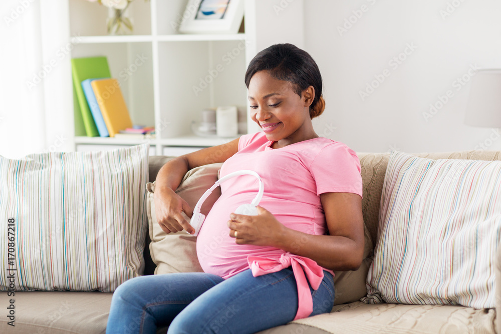 pregnant woman with headphones at home pregnant woman with headphones at home