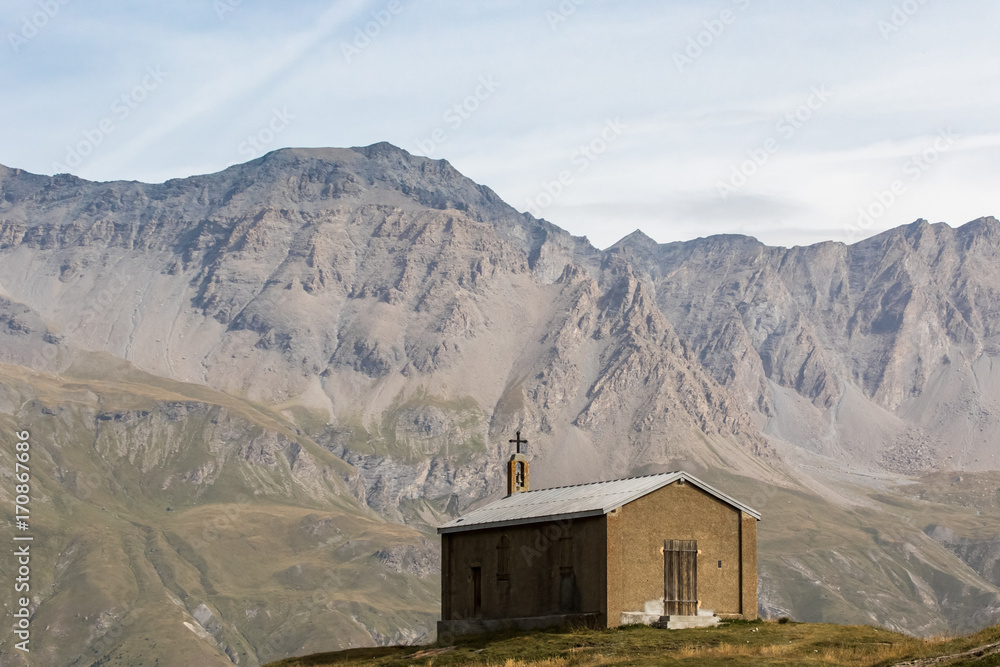 Small chapel with mountains alps in the background