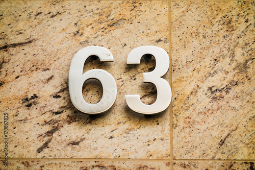 number 63 on marble background photo