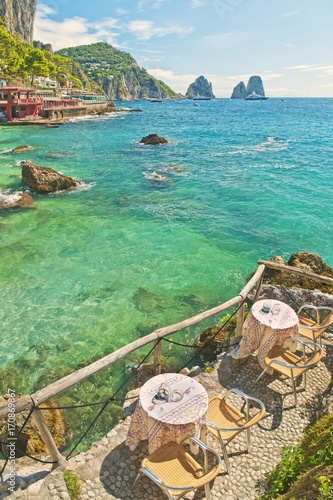 two tables at beach cafe with sea and mountain view