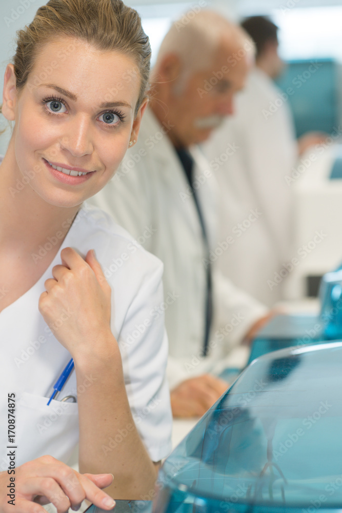 nurse assistant with white coat smiling at camera nurse assistant with white coat smiling at camera
