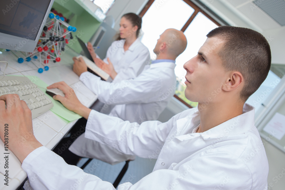 scientist examining dna model in laboratory scientist examining dna model in laboratory