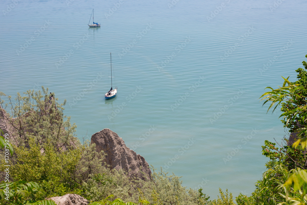 scenic view of sail boats in a bay at Scarborough Bluffs in Toronto