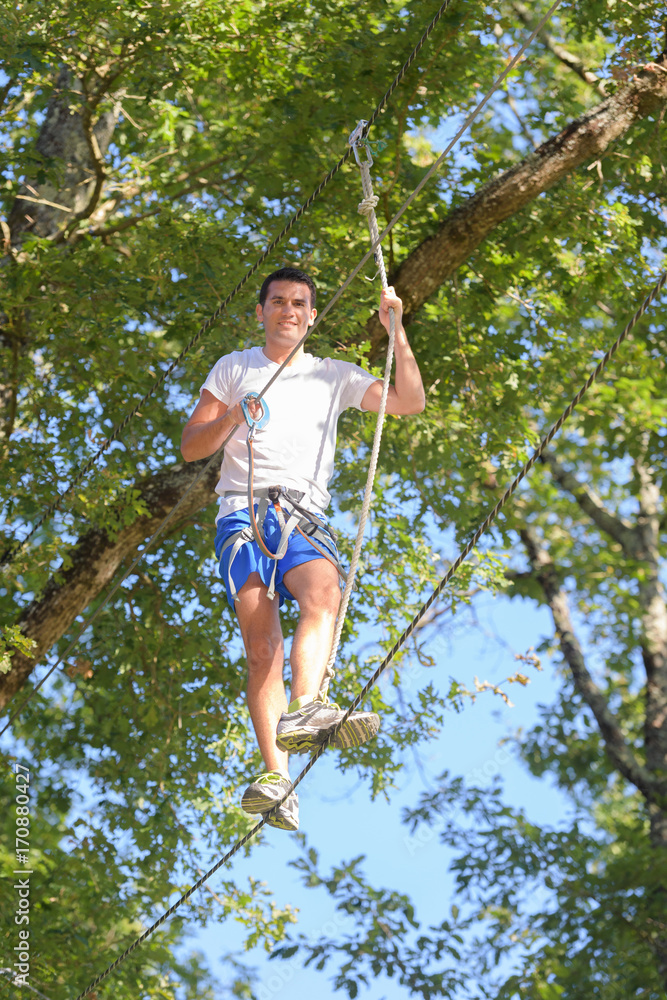 climber man holding a rope in the adventure park climber man holding a rope in the adventure park