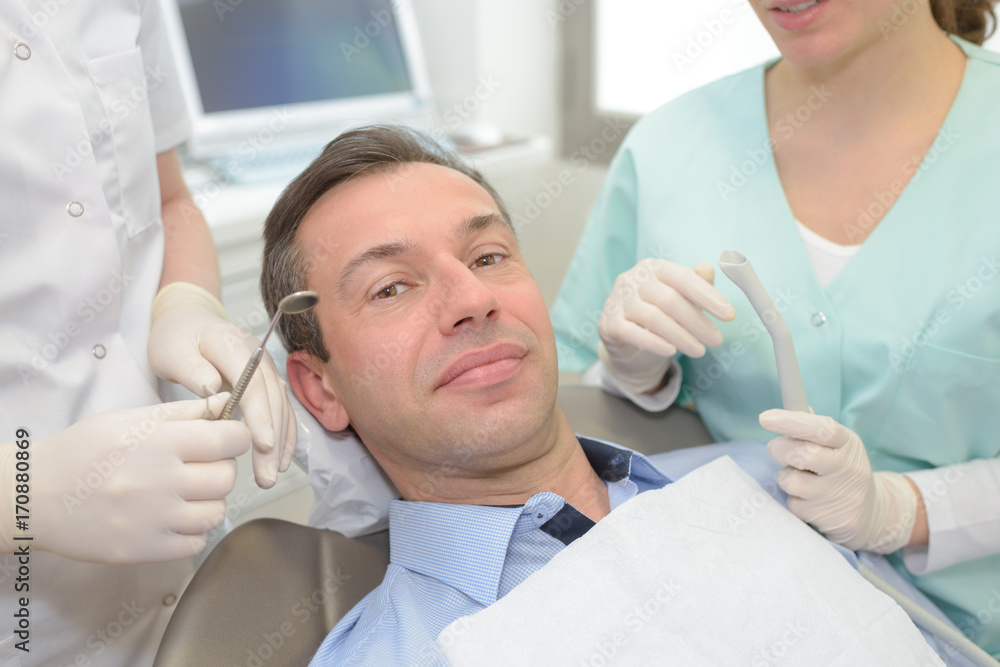 Fototapeta premium entist and happy man in a dentist office