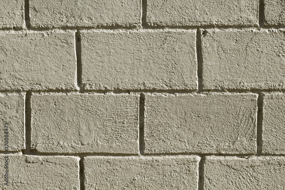 Fototapeta premium Concrete brick wall photo background. Rough grey stone bricks design.