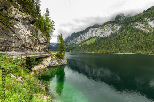 Great azure alpine lake Vorderer Gosausee. Picturesque and gorgeous rain clouds