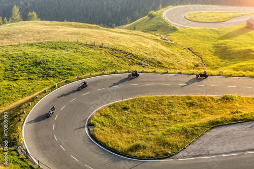 Motorcycle drivers riding in Alpine highway. Outdoor photography photo