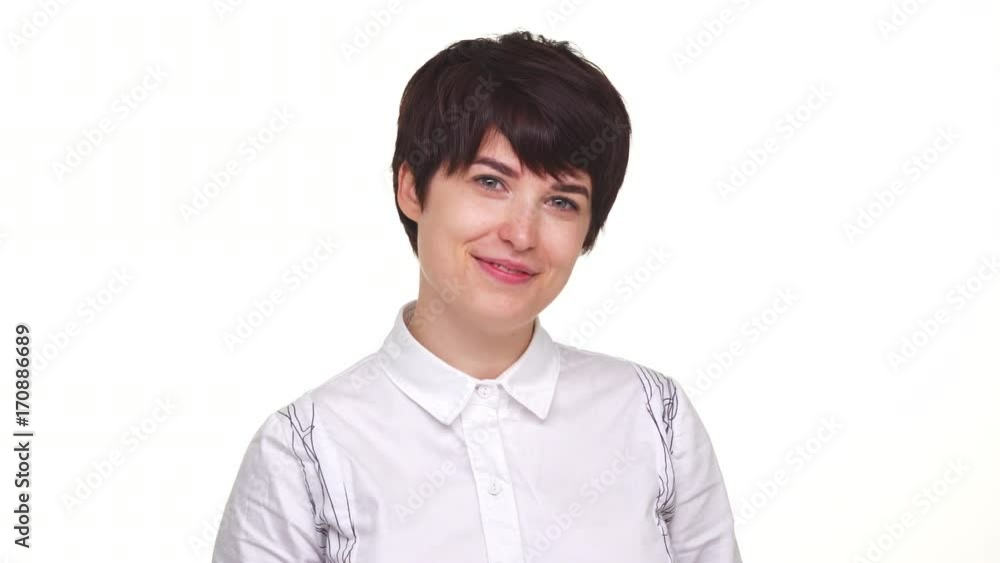 Goodlooking lady with short haircut looking at camera and smiling isolated over white backgrouund. Concept of emotions Goodlooking lady with short haircut looking at camera and smiling isolated over white backgrouund. Concept of emotions