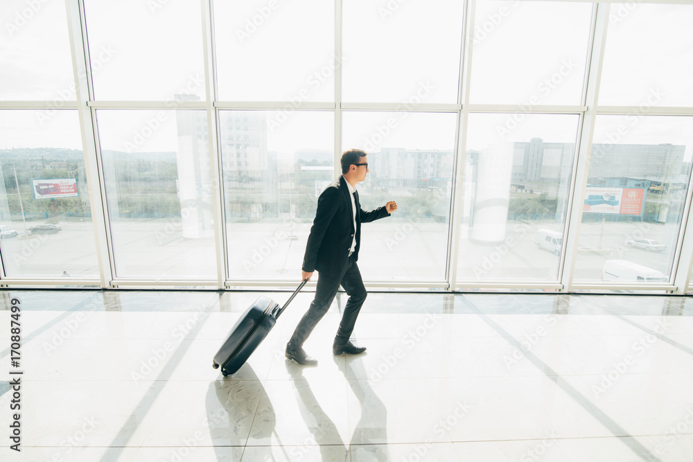Business man at international airport runing to terminal gate for airplane travel trip Business man at international airport runing to terminal gate for airplane travel trip