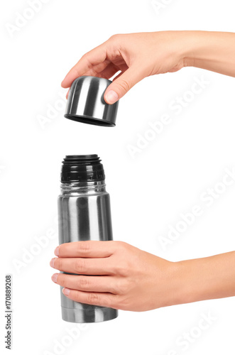metal thermos for trips in hand isolated on white background