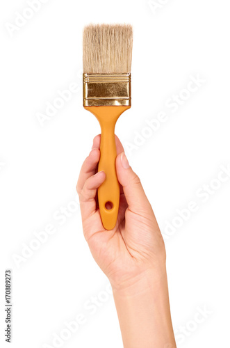 orange Paint brush in hand isolated on white background