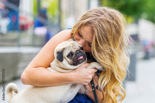 young woman kisses her pug © Christian Müller