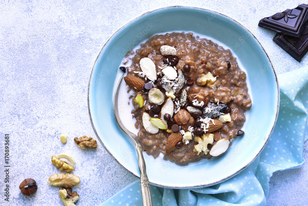 Chocolate oat porridge with nuts.Top view. Chocolate oat porridge with nuts.Top view.
