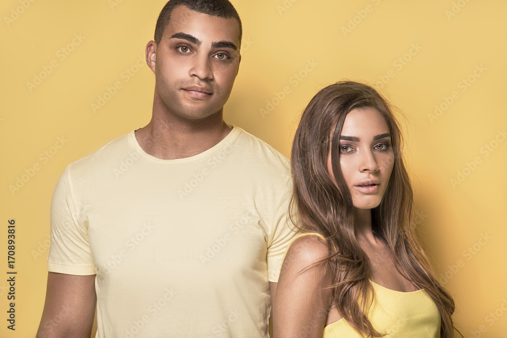 Beautiful couple posing on yellow background. Beautiful couple posing on yellow background.