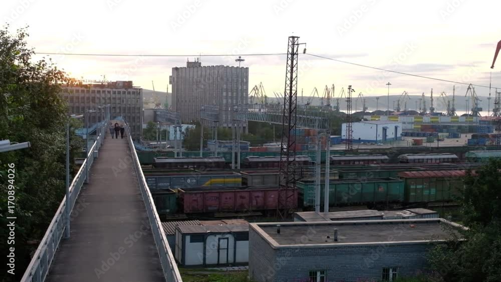 The view of the train station on the background of the port and cranes The view of the train station on the background of the port and cranes