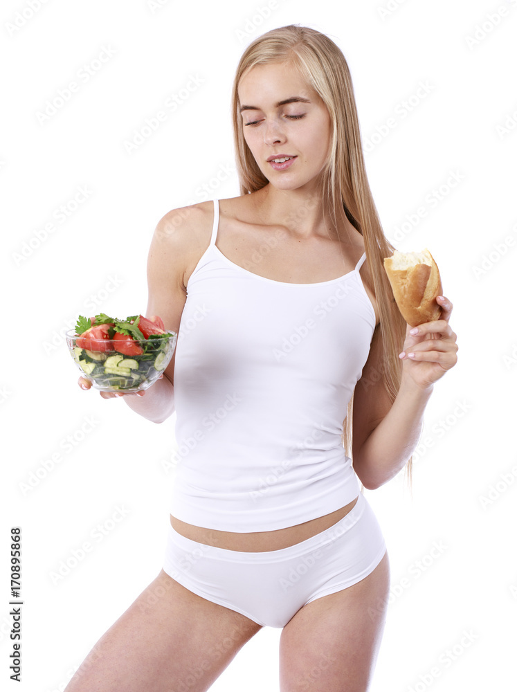Young woman with a plate of vegetable salad and white bread Young woman with a plate of vegetable salad and white bread