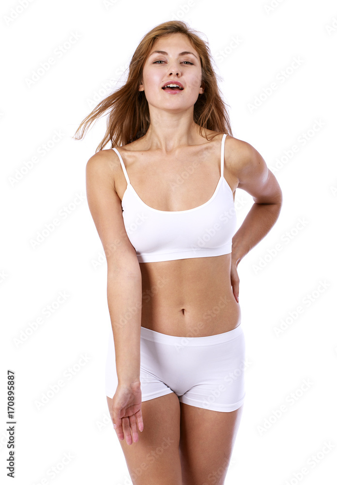 Young beautiful blonde woman in white fitness clothing Young beautiful blonde woman in white fitness clothing